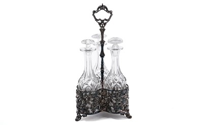 Lot 979 - A silver-plated triple decanter stand