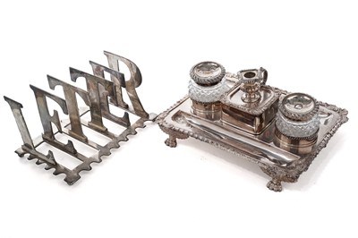 Lot 1058 - An early 20th Century silver-plated desk stand; and a plated metal letter rack