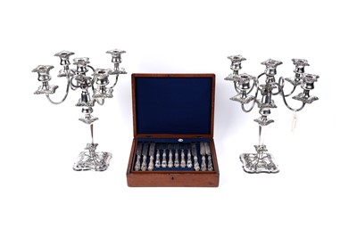 Lot 506 - A pair of silver plated candelabra; and an oak canteen of cutlery