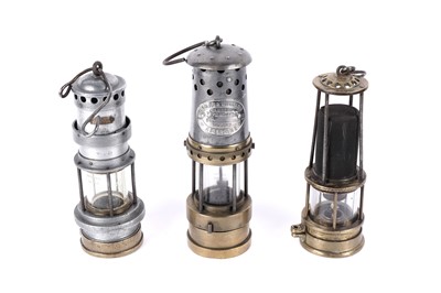 Lot 1443 - Three miners’ lamps; together with a Clanny style lamp