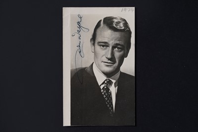 Lot 713 - A John Wayne signed portrait photograph