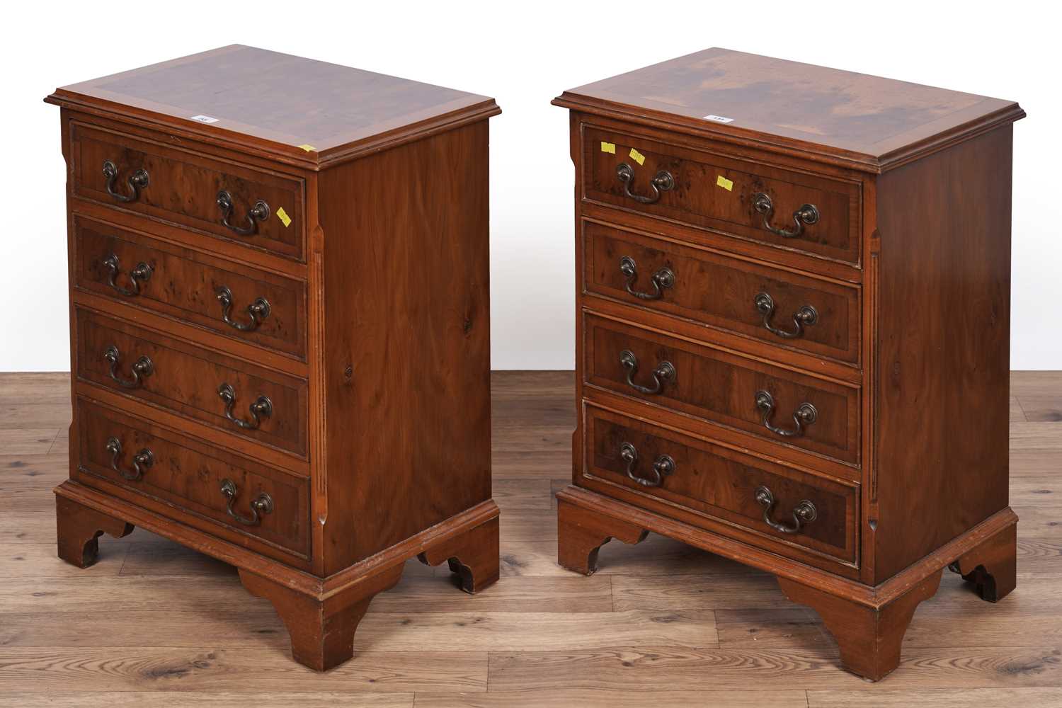 Lot 135 - A pair of Georgian style yew veneered bedside chests