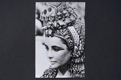 Lot 732 - An Elizabeth Taylor autographed black and white photographic postcard