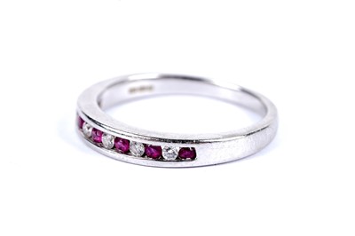 Lot 94 - A ruby and diamond half hoop eternity ring