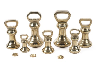 Lot 310 - A graduated set of brass weights by W&T Avery Ltd