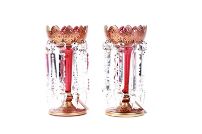 Lot 483 - A pair of Victorian cranberry glass lustres