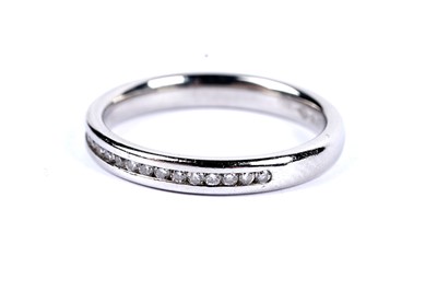 Lot 10 - A diamond half hoop eternity ring