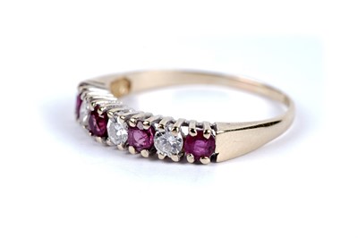 Lot 53 - A ruby and diamond half hoop eternity ring