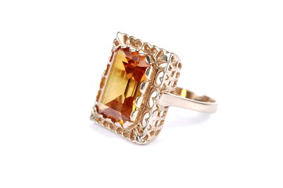 Lot 12 - A synthetic fancy orange sapphire single stone ring