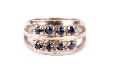 Lot 46 - A sapphire and diamond half hoop eternity ring; and another