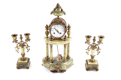 Lot 171 - A French onyx and gilt metal clock and garniture by Mesnard & Fils