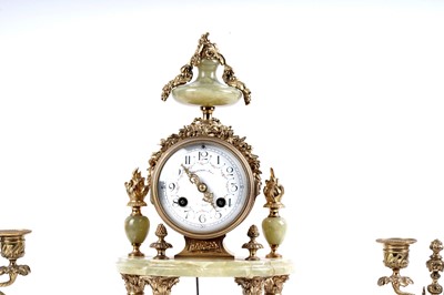 Lot 171 - A French onyx and gilt metal clock and garniture by Mesnard & Fils