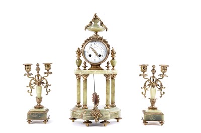 Lot 171 - A French onyx and gilt metal clock and garniture by Mesnard & Fils