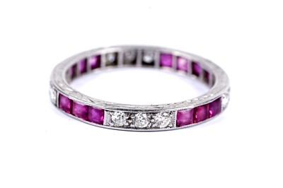 Lot 145 - A ruby and diamond eternity ring