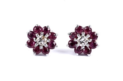 Lot 146 - A pair of ruby and diamond cluster earrings