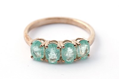 Lot 157 - An emerald four stone dress ring