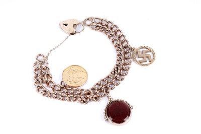 Lot 168 - A 9ct gold curb link bracelet with a sovereign and other charms