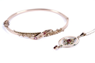 Lot 199 - An Edwardian 9ct rose gold bangle; and a red paste drop pendant necklace