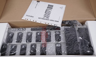 Lot 601 - A boxed Behringer Midi foot controller; and a bass amplifier