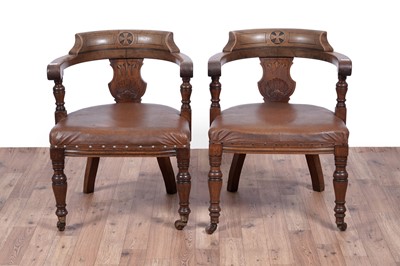 Lot 7 - A pair of early 20th Century ecclesiastical walnut captain's armchairs