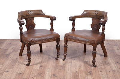 Lot 7 - A pair of early 20th Century ecclesiastical walnut captain's armchairs