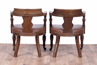 Lot 7 - A pair of early 20th Century ecclesiastical walnut captain's armchairs