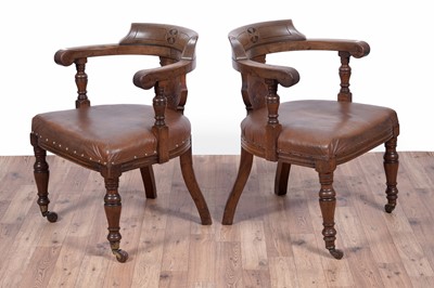 Lot 7 - A pair of early 20th Century ecclesiastical walnut captain's armchairs