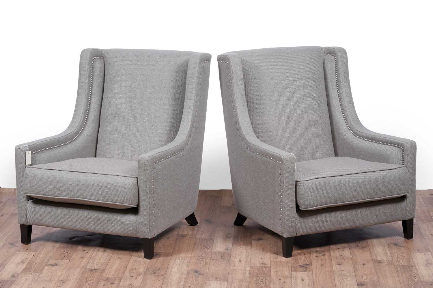 Lot 33 - Kelly Hoppen: a pair of ‘Emma’ wingback armchairs