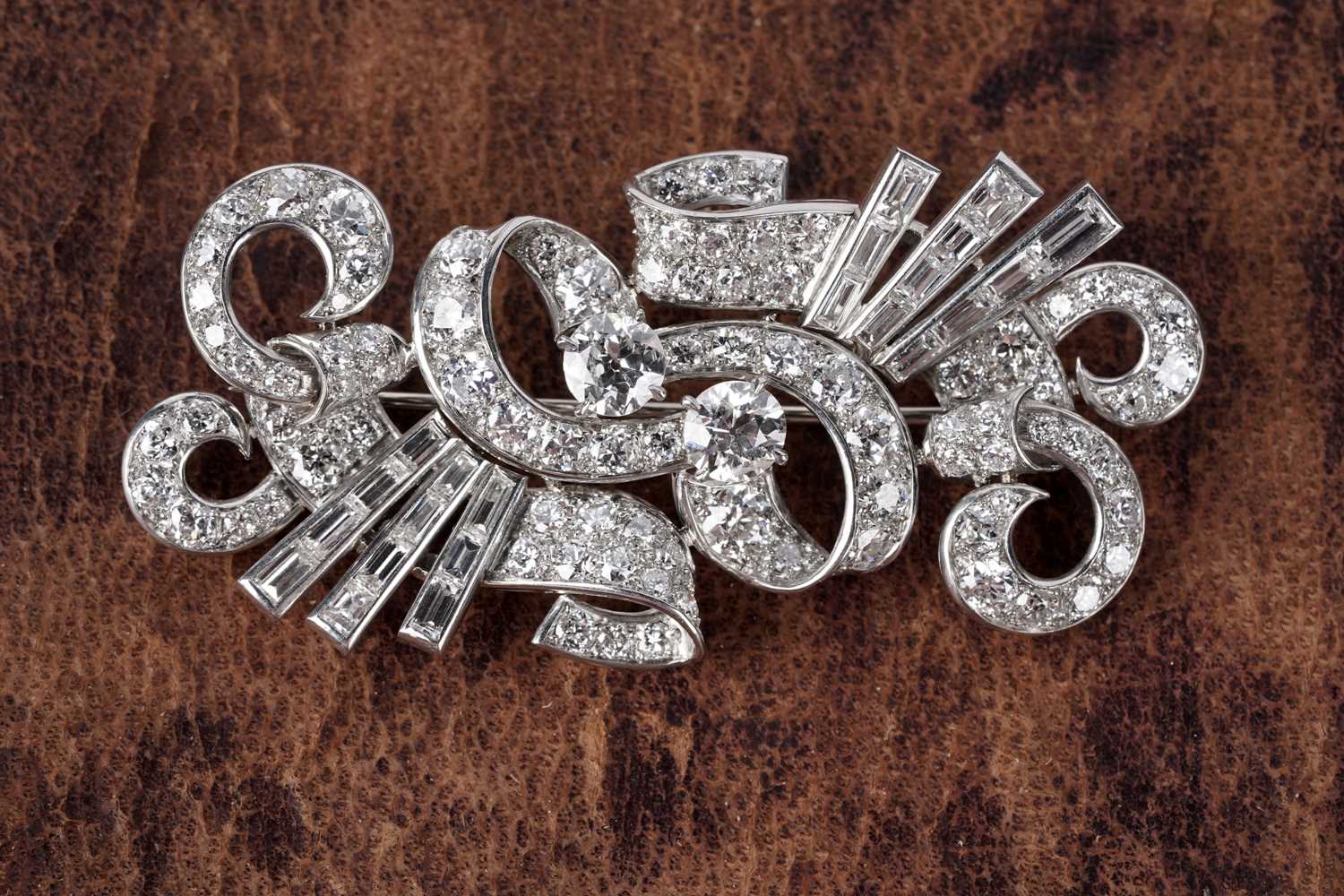Diamond Scroll Lot 729 - An Art Deco diamond scroll brooch