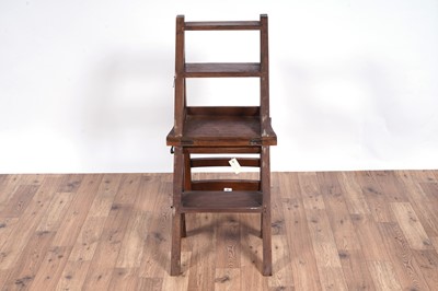 Lot 72 - A 20th Century stained hardwood metamorphic library chair