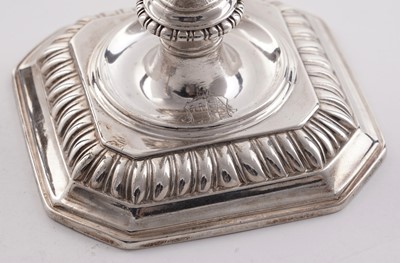 Lot 66 - A pair of William III silver cast candlesticks