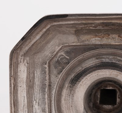 Lot 66 - A pair of William III silver cast candlesticks