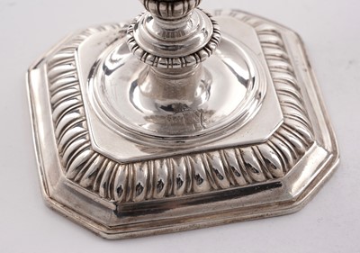 Lot 66 - A pair of William III silver cast candlesticks