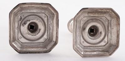 Lot 66 - A pair of William III silver cast candlesticks