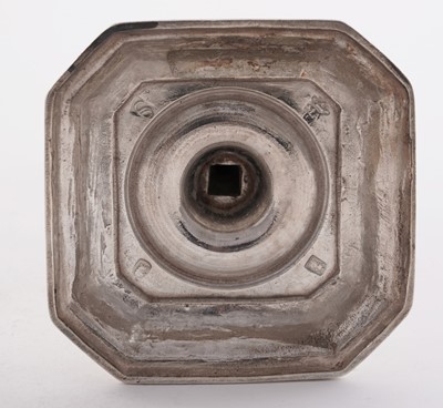 Lot 66 - A pair of William III silver cast candlesticks