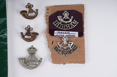 Lot 5 - A selection of Durham Light Infantry cap badges, titles, and buttons
