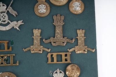 Lot 6 - A display of badges, titles and buttons for Dragoon, Hussar and Lancer regiments