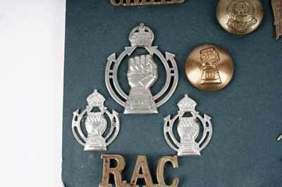 Lot 6 - A display of badges, titles and buttons for Dragoon, Hussar and Lancer regiments