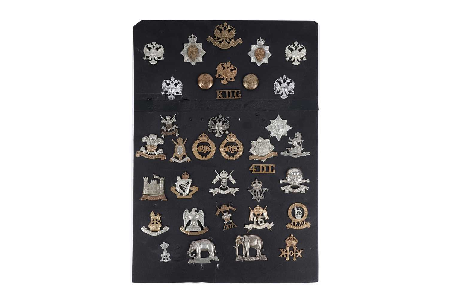 Lot 8 - A display of cap badges, titles and buttons for Dragoon Guard, Lancer and Hussar Regiments