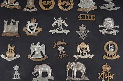 Lot 8 - A display of cap badges, titles and buttons for Dragoon Guard, Lancer and Hussar Regiments