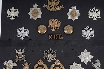 Lot 8 - A display of cap badges, titles and buttons for Dragoon Guard, Lancer and Hussar Regiments