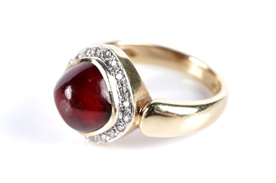 Lot 579 - A garnet cabochon and diamond cluster ring