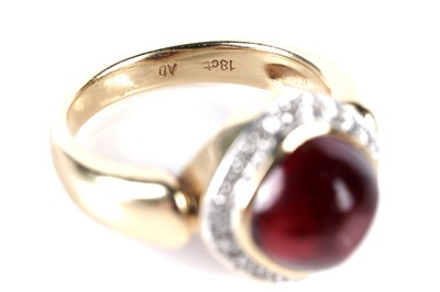 Lot 579 - A garnet cabochon and diamond cluster ring
