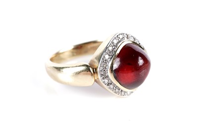 Lot 579 - A garnet cabochon and diamond cluster ring