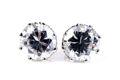 Lot 77 - A three stone dress ring; and a pair of stud earrings