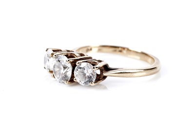 Lot 77 - A three stone dress ring; and a pair of stud earrings