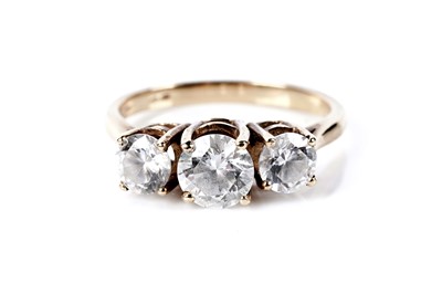 Lot 77 - A three stone dress ring; and a pair of stud earrings