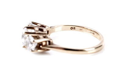 Lot 77 - A three stone dress ring; and a pair of stud earrings