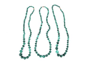 Lot 671 - A set of three malachite bead necklaces; and a pair of cultured pearl earrings