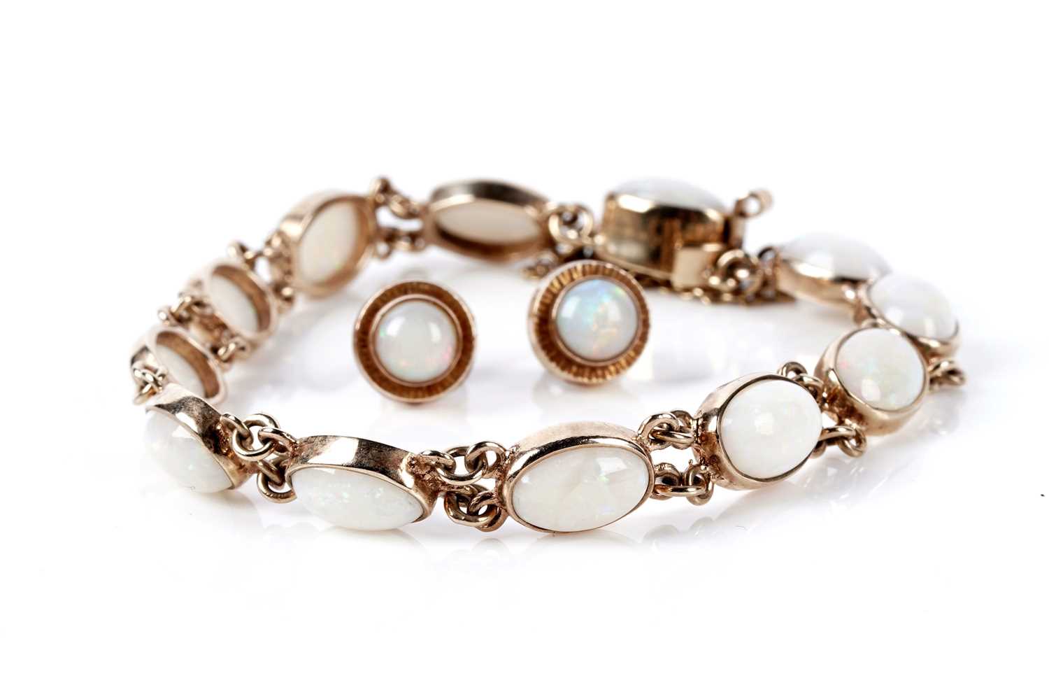 Lot 73 - An opal cabochon bracelet; and a pair of opal stud earrings